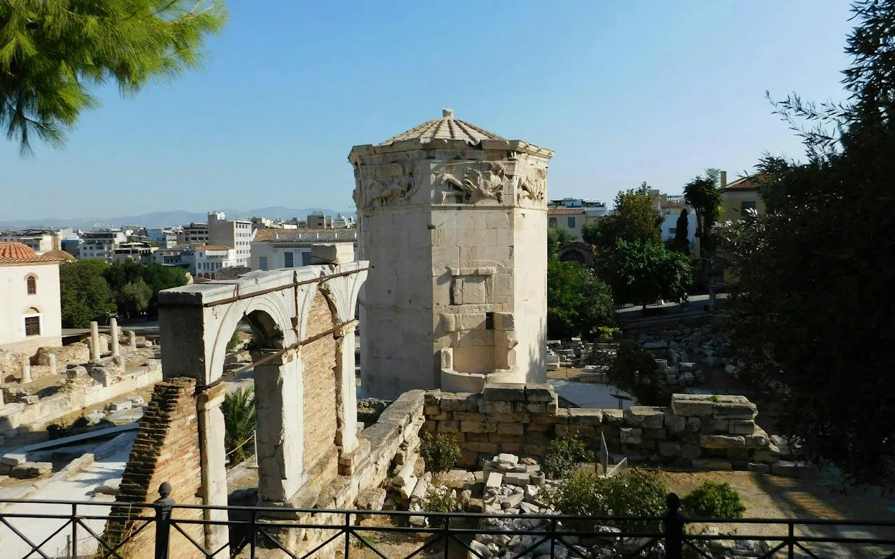 Ancient Tower of the Winds in Plaka, Athens, surrounded by historic ruins.