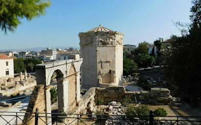 Ancient Tower of the Winds in Plaka, Athens, surrounded by historic ruins.