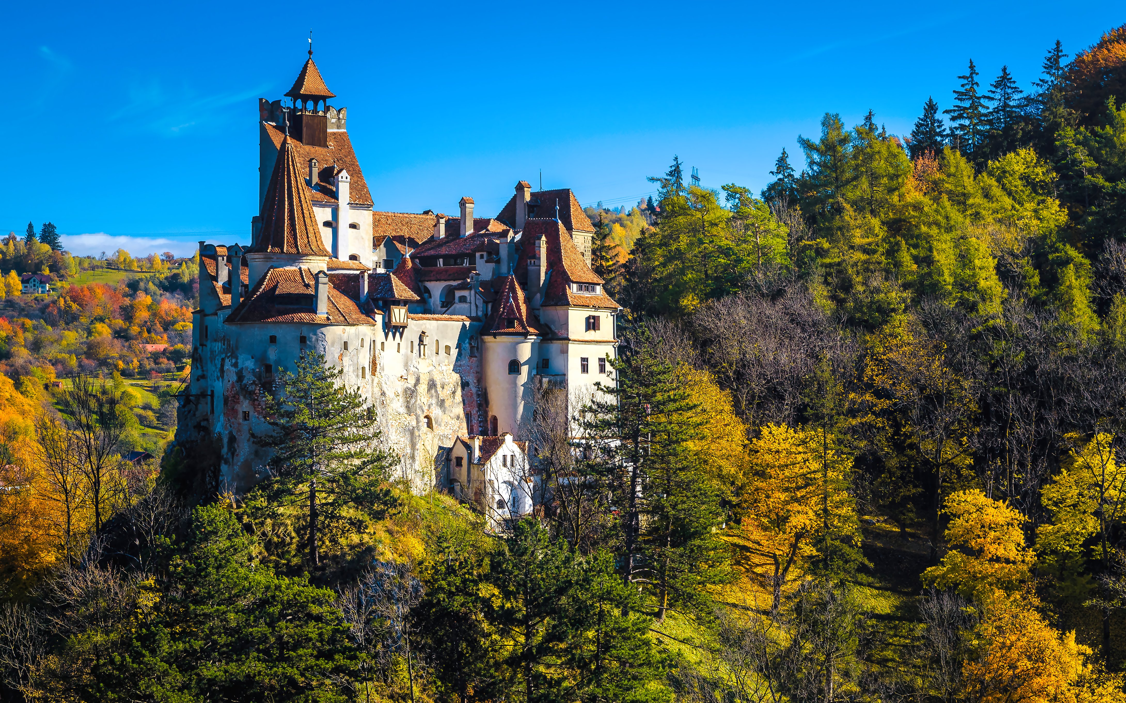 Bran Castle surrounded by autumn trees in Transylvania, Romania.