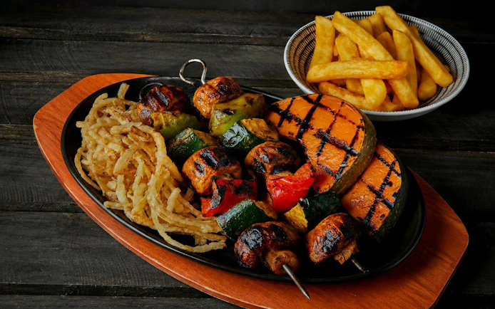 Grilled vegetable skewers and crispy onions on a platter, Tomb of the Pharaoh Sunset tour.