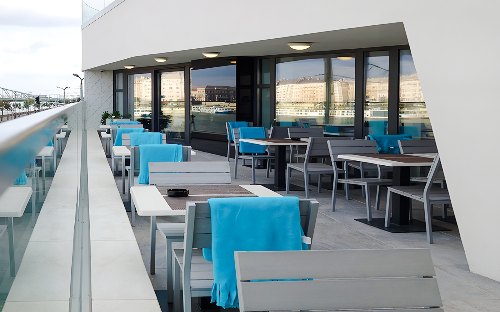Outdoor seating at a restaurant near Rudas Bath, Budapest, with tables and chairs set for dining.