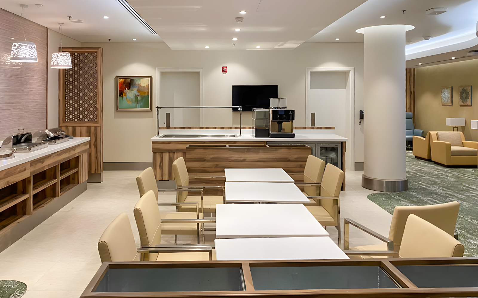 Premium lounge seating area at Jeddah Airport with dining tables and modern decor.
