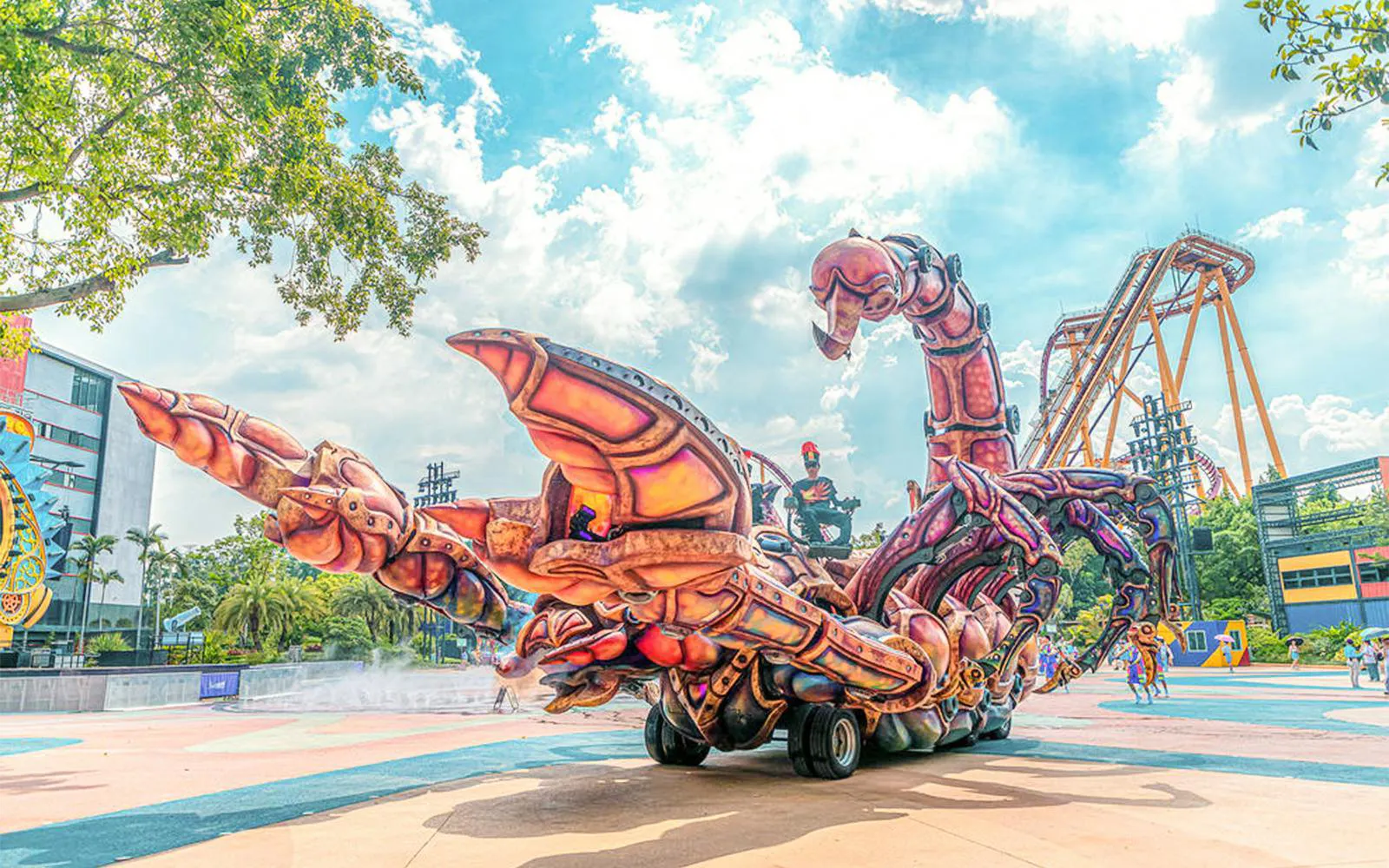 Giant scorpion-themed ride at Chimelong Paradise with roller coaster in background.