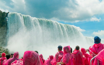 Tourists in pink ponchos on a boat cruise near Niagara Falls.