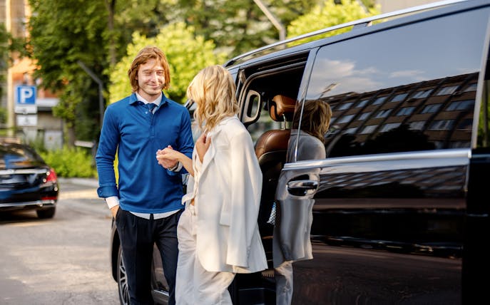Guests entering a minivan for a city tour.