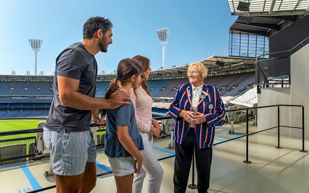 Tour group with guide at Melbourne Cricket Ground overlooking the stadium.