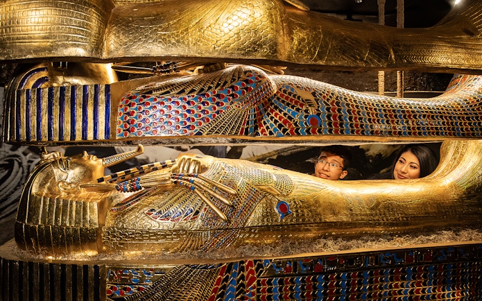 Visitors inside a replica of an Egyptian sarcophagus at a Las Vegas attraction.