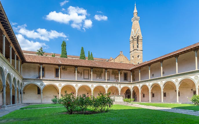 Cloisters of Santa Croce Basilica Complex with arches and central garden in Florence.
