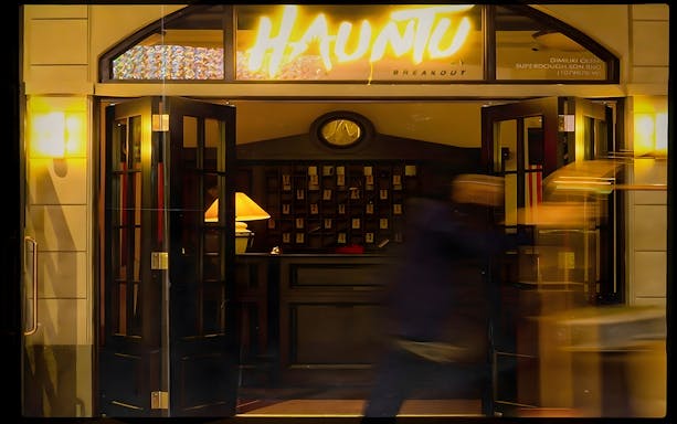 Entrance to Hauntu experience in Malaysia with open doors and dim lighting.