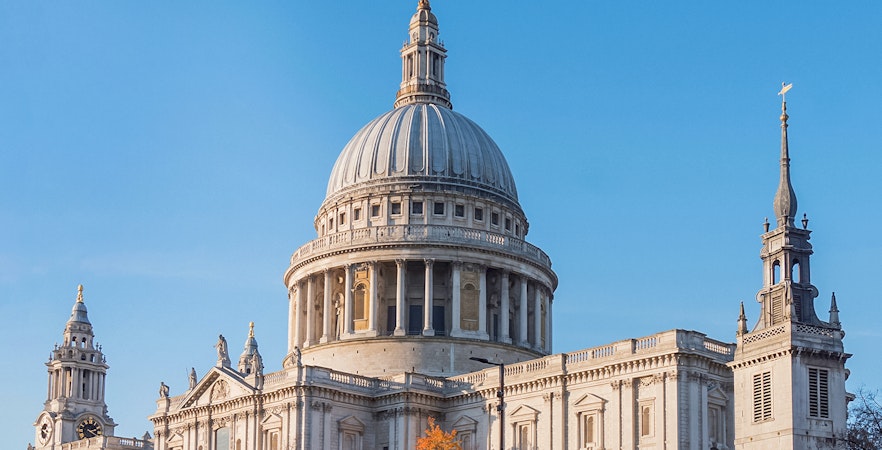 St Paul's Cathedral dome and towers against a clear blue sky in London.