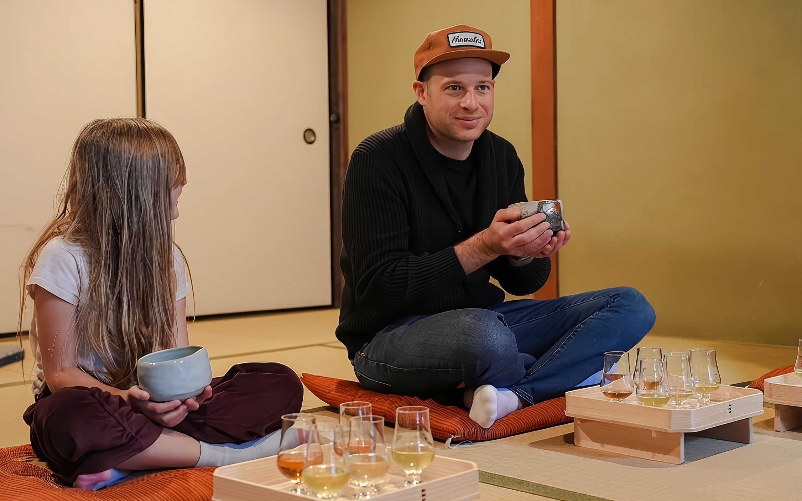 Father and daughter enjoying a private tea ceremony with seasonal wagashi in a traditional setting.