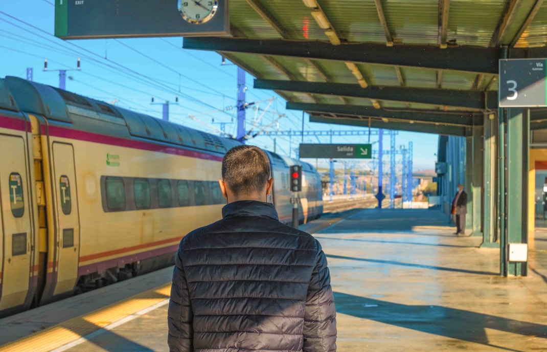 Madrid train at Atocha Station with travelers boarding.