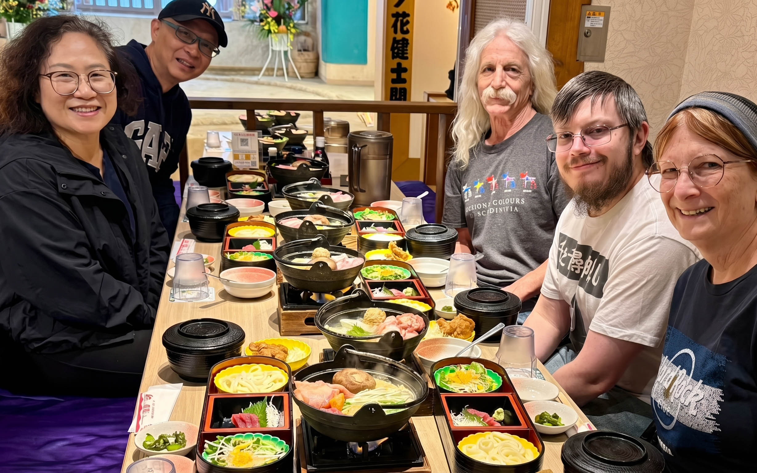 Group enjoying traditional Japanese meal before Tokyo Grand Sumo Tournament.