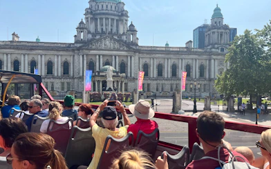 Open-top bus tour in front of Belfast City Hall.