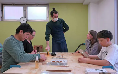 Participants crafting chopsticks in a Tokyo Shinjuku class.