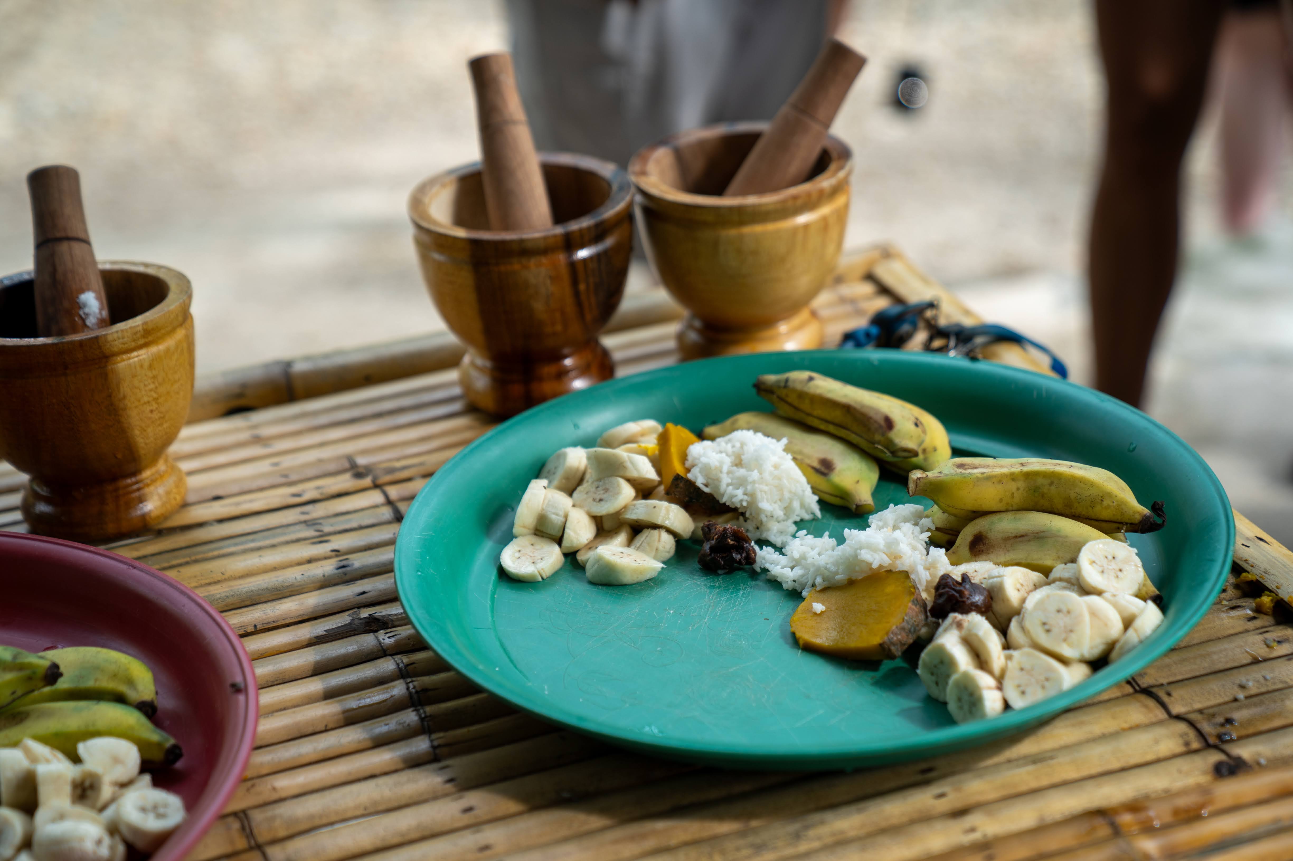 Preparing elephant food with bananas and rice at Khaolak Ethical Elephant Sanctuary.