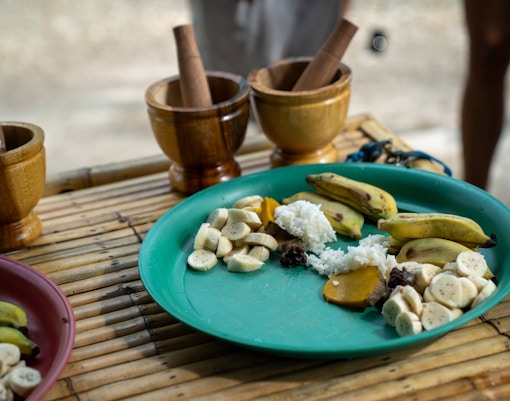 Preparing elephant food with bananas and rice at Khaolak Ethical Elephant Sanctuary.