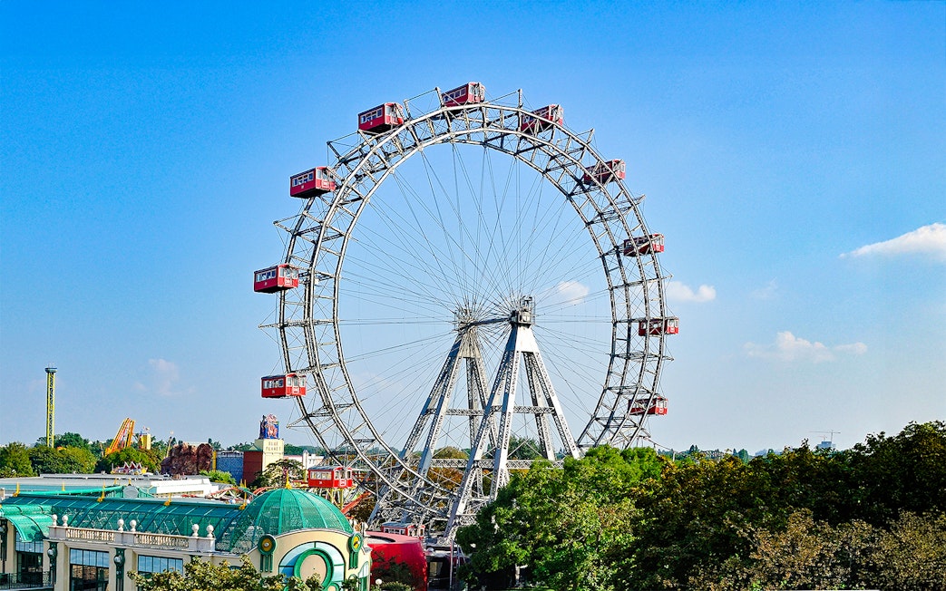 Vienna Giant Ferris Wheel with red cabins against a clear blue sky.
