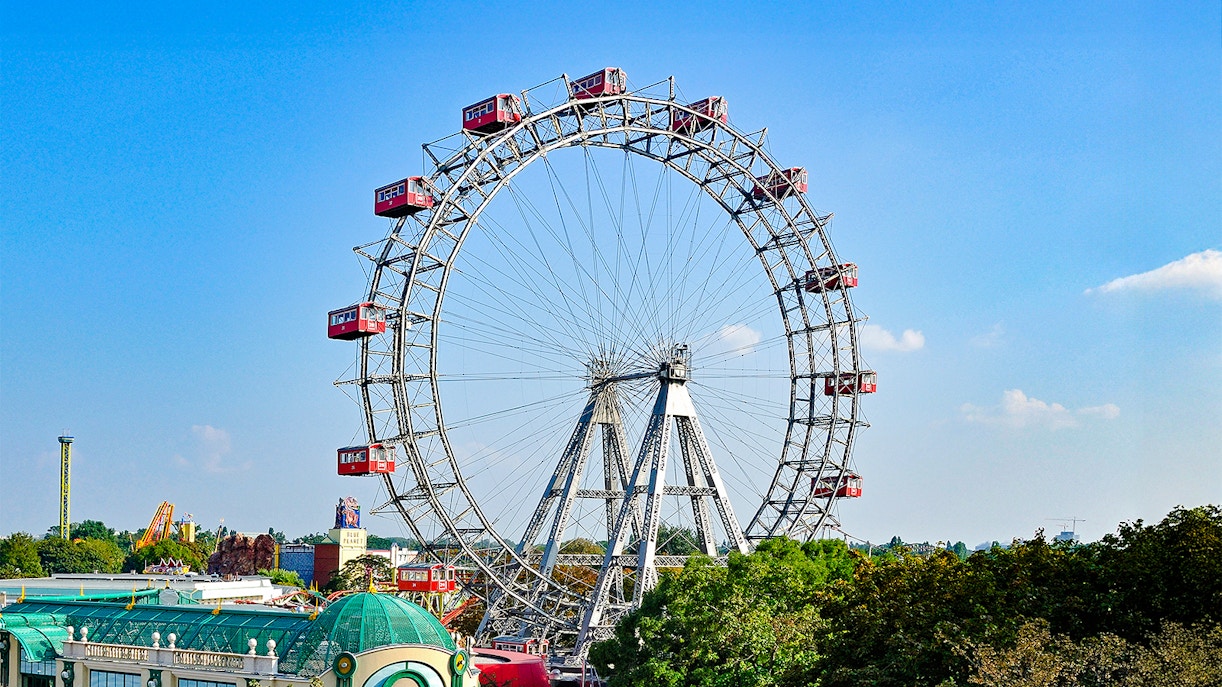Vienna Giant Ferris Wheel with red cabins against a clear blue sky.