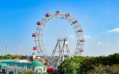 Vienna Giant Ferris Wheel with red cabins against a clear blue sky.