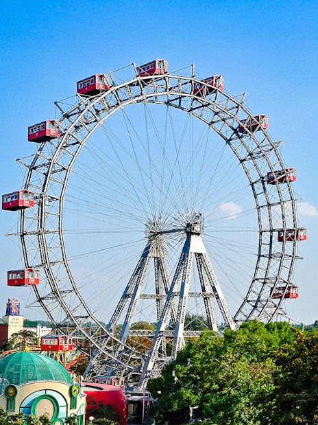 Vienna Giant Ferris Wheel with red cabins against a clear blue sky.