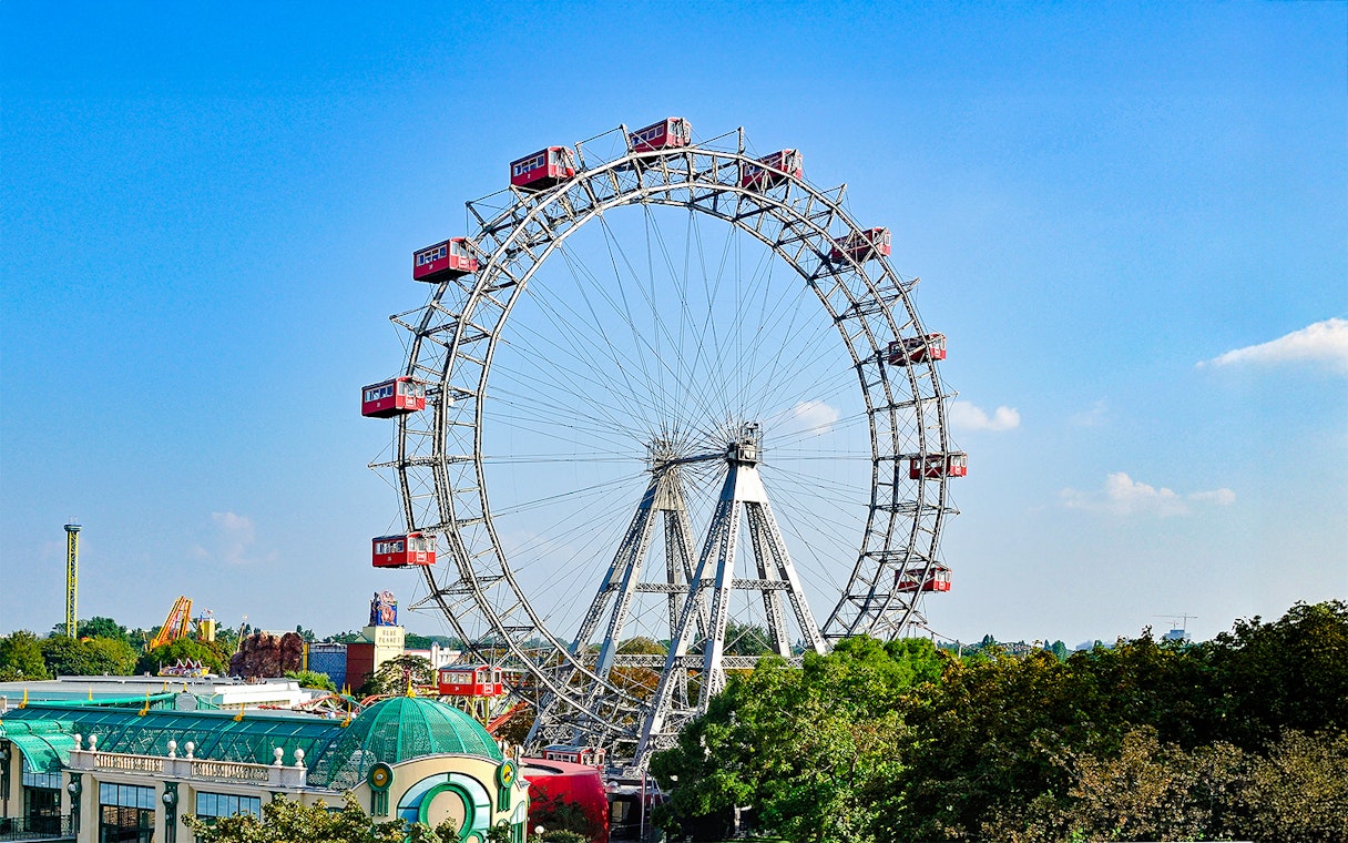 Vienna Giant Ferris Wheel with red cabins against a clear blue sky.