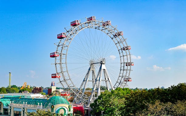 Vienna Giant Ferris Wheel with red cabins against a clear blue sky.