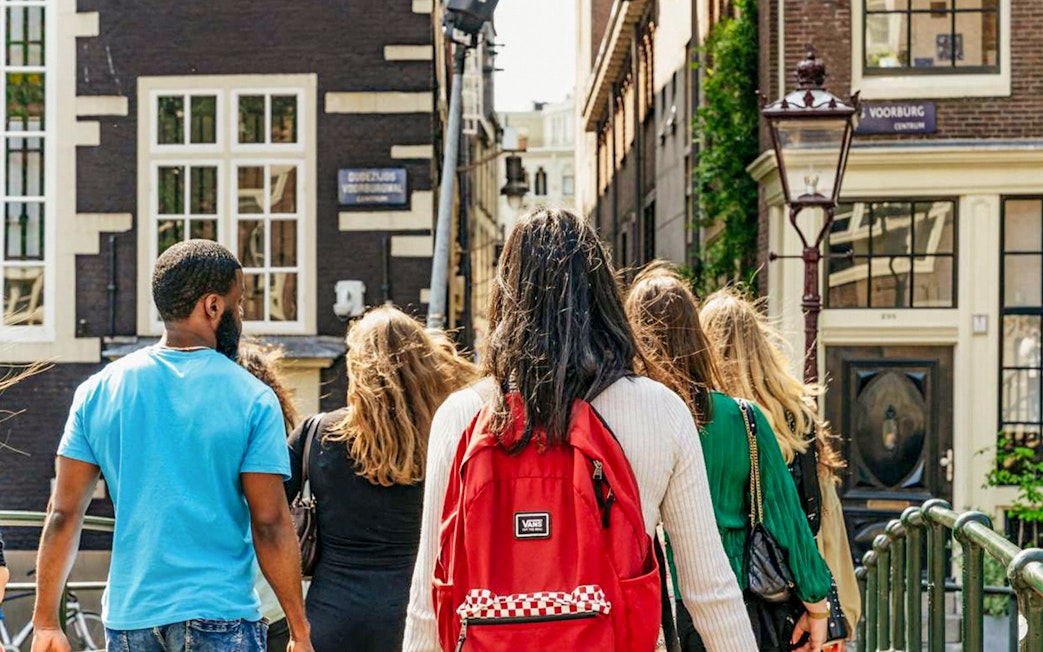 Group walking through Amsterdam on Anne Frank tour near Jewish Museum.
