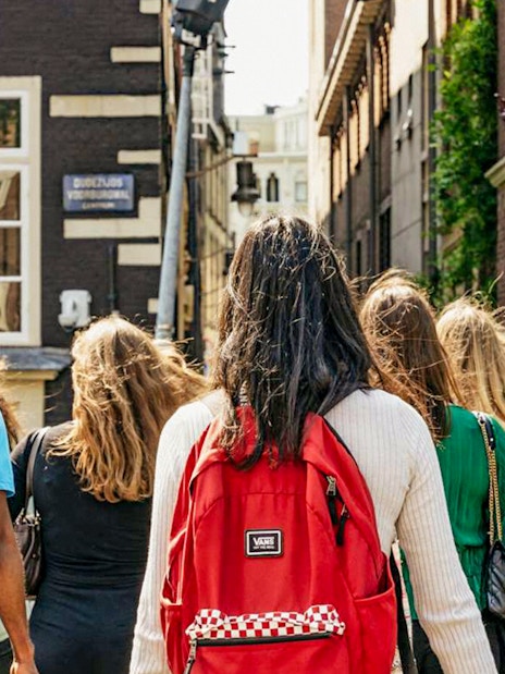 Group walking through Amsterdam on Anne Frank tour near Jewish Museum.