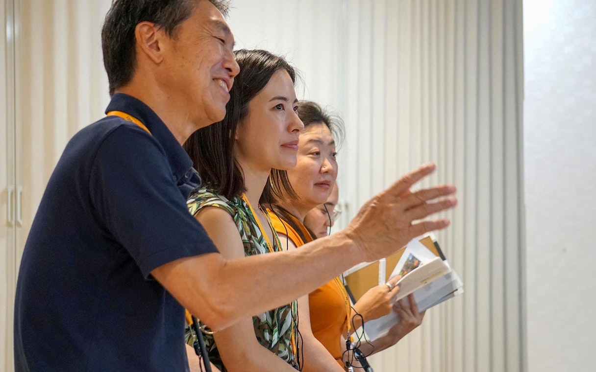 Guests observing inside a sumo stable in Japan.