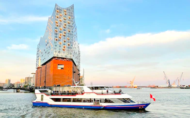Tour boat passing Elbphilharmonie on Hamburg harbor tour.