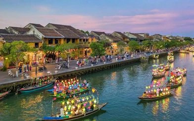 Boat ride with colorful lanterns on a canal, offering free herbal drink, Dubai.