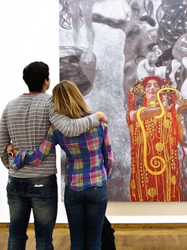 Couple admiring Klimt painting at Leopold Museum, Vienna.
