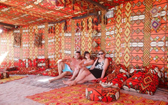 Visitors relaxing in a traditional Bedouin tent on the Giftun 3 Islands Tour.