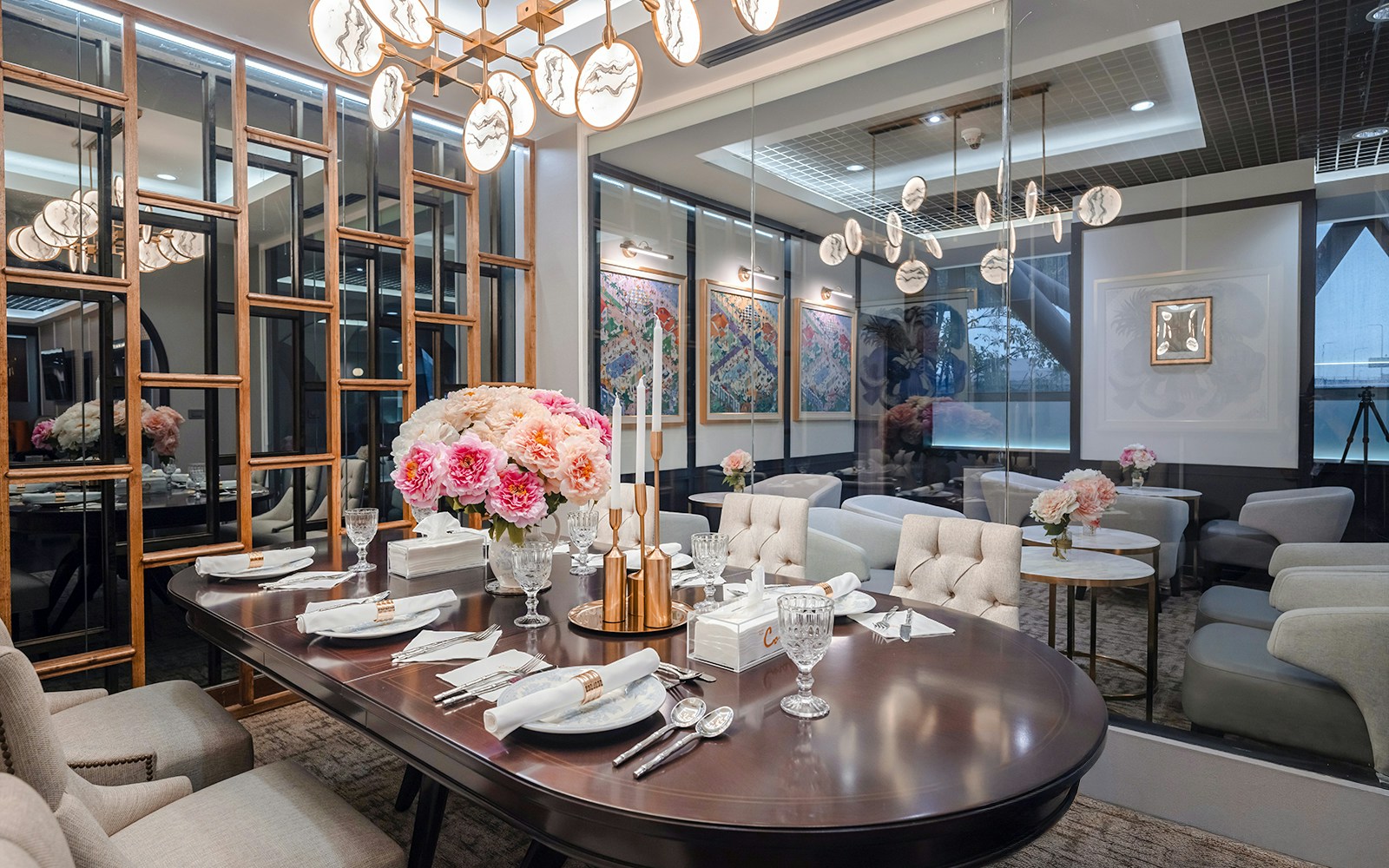 Dining area in The Coral First Class Lounge, Bangkok airport, featuring elegant table setting and floral decor.