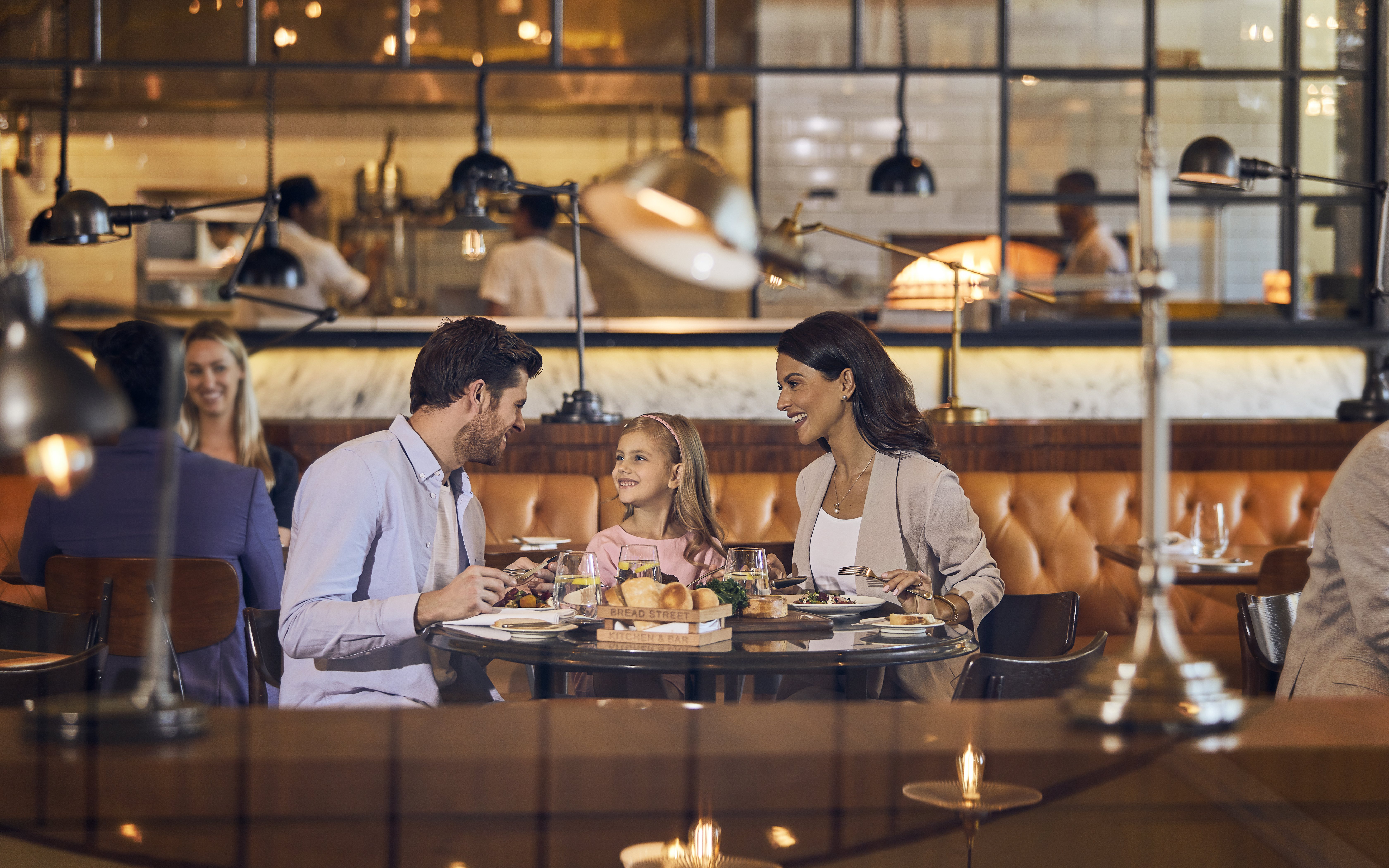 Family dining at Bread Street Kitchen, Dubai, enjoying set menu by Gordon Ramsay.