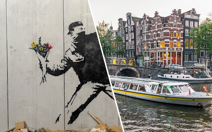 Banksy artwork with flowers and Amsterdam canal cruise boat near historic buildings.