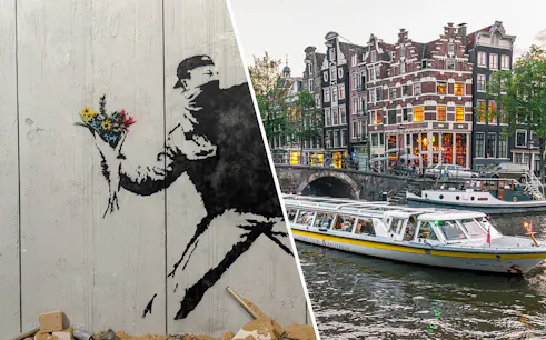 Banksy artwork with flowers and Amsterdam canal cruise boat near historic buildings.