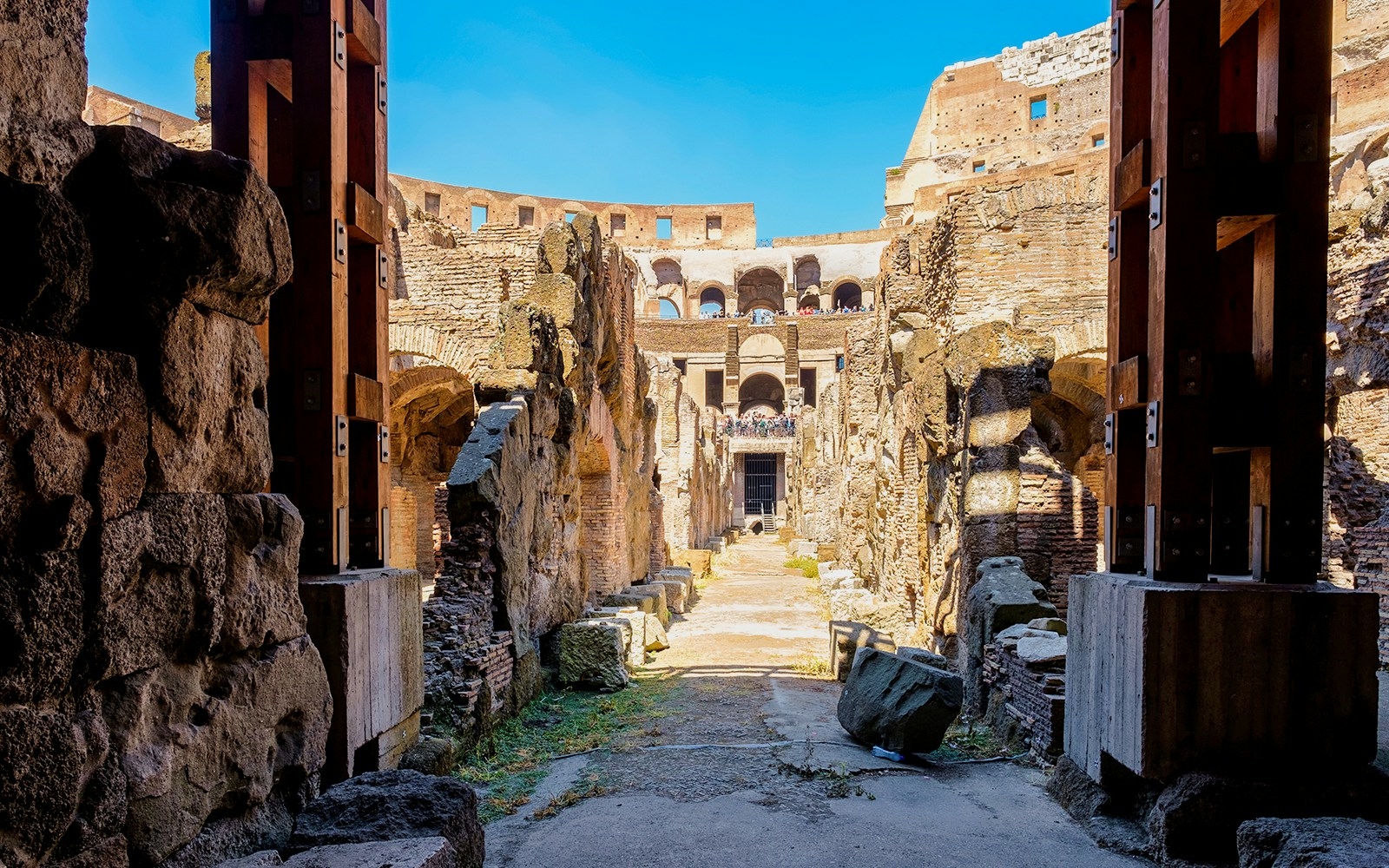 Colosseum underground passageway with ancient stone walls in Rome, Italy.