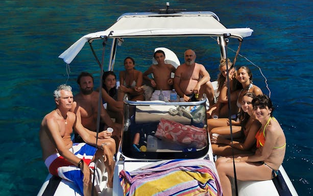 Sant'Antioco Island sightseeing cruise with skipper, featuring coastal views and clear blue waters.