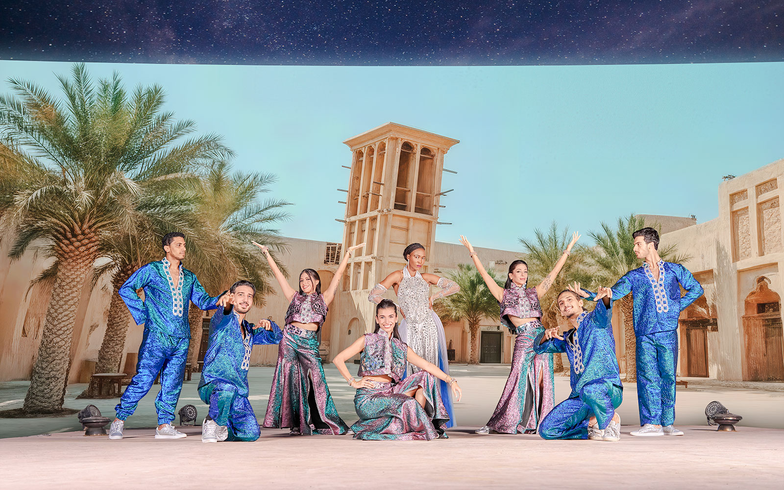 Performers in colorful costumes at Noble Camp Desert Safari live entertainment.