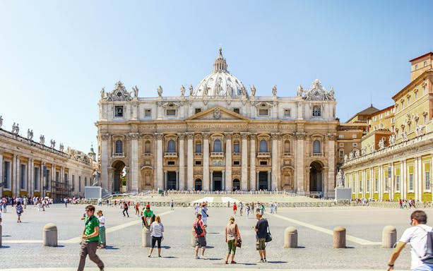 Basilica of Saint Peter facade with tourists in Vatican City, Rome.