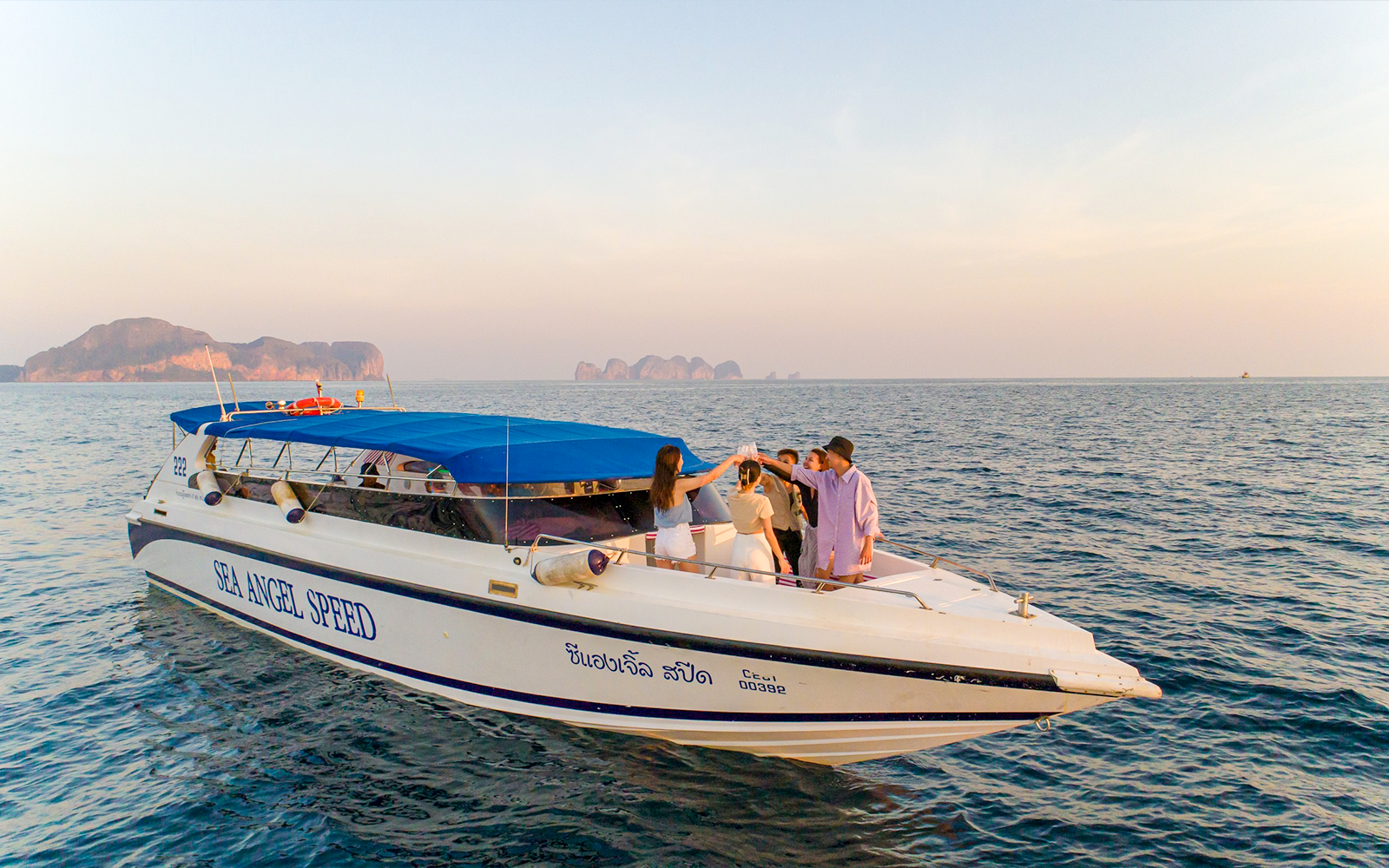 Speedboat with people at sunset near Phi Phi Islands, Thailand.