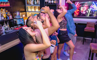 Group of friends enjoying drinks at a bar in Rome.