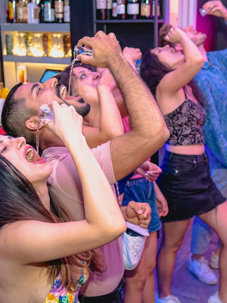 Group of friends enjoying drinks at a bar in Rome.