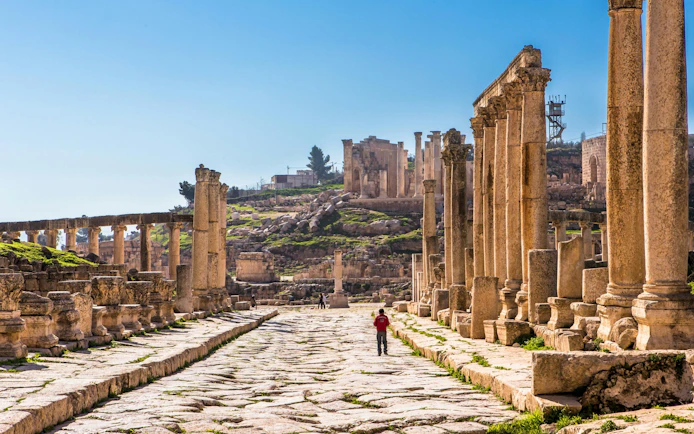 Ancient Roman columns lining the stone street of Jerash ruins in Jordan.