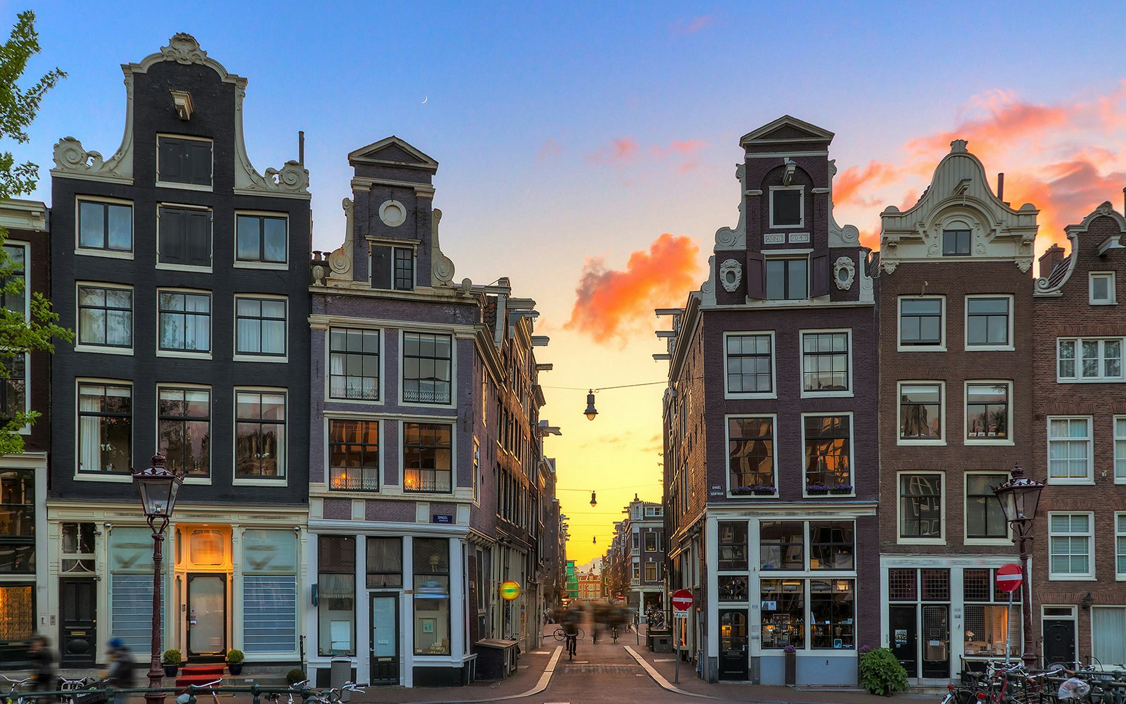 Amsterdam's Negen Straatjes at sunset with historic canal houses.