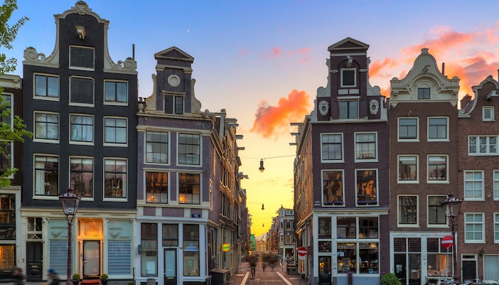 Amsterdam's Negen Straatjes at sunset with historic canal houses.
