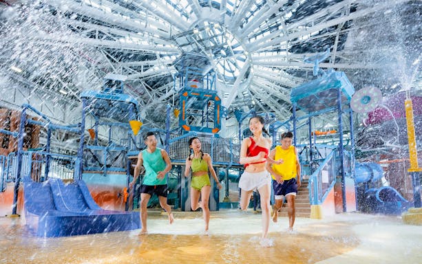 Visitors at the indoor rain dance in Macau Studio City Water Park