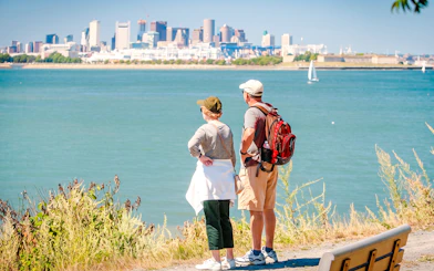 Couple viewing Boston skyline from Spectacle Island, accessible by ferry.